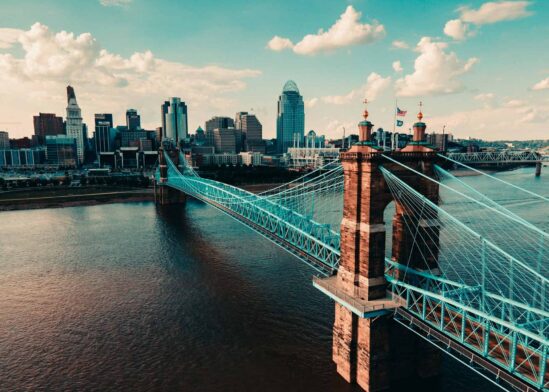 This image shows a cityscape of Cincinnati's Roebling Bridge.